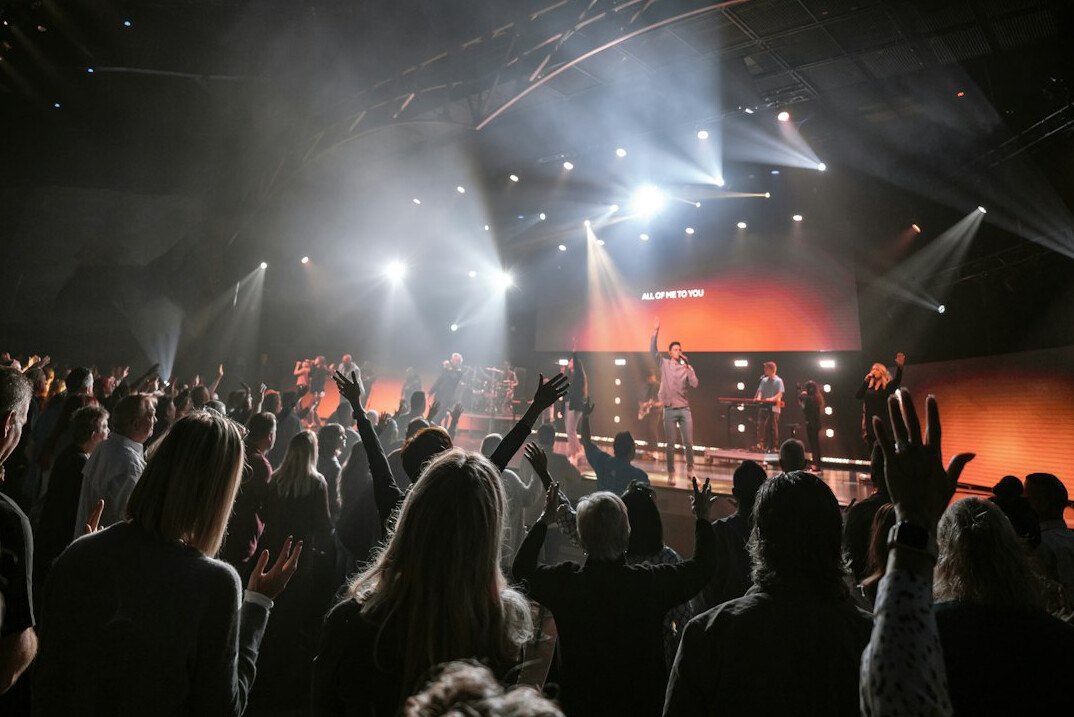 Live event stage with large screens and audience