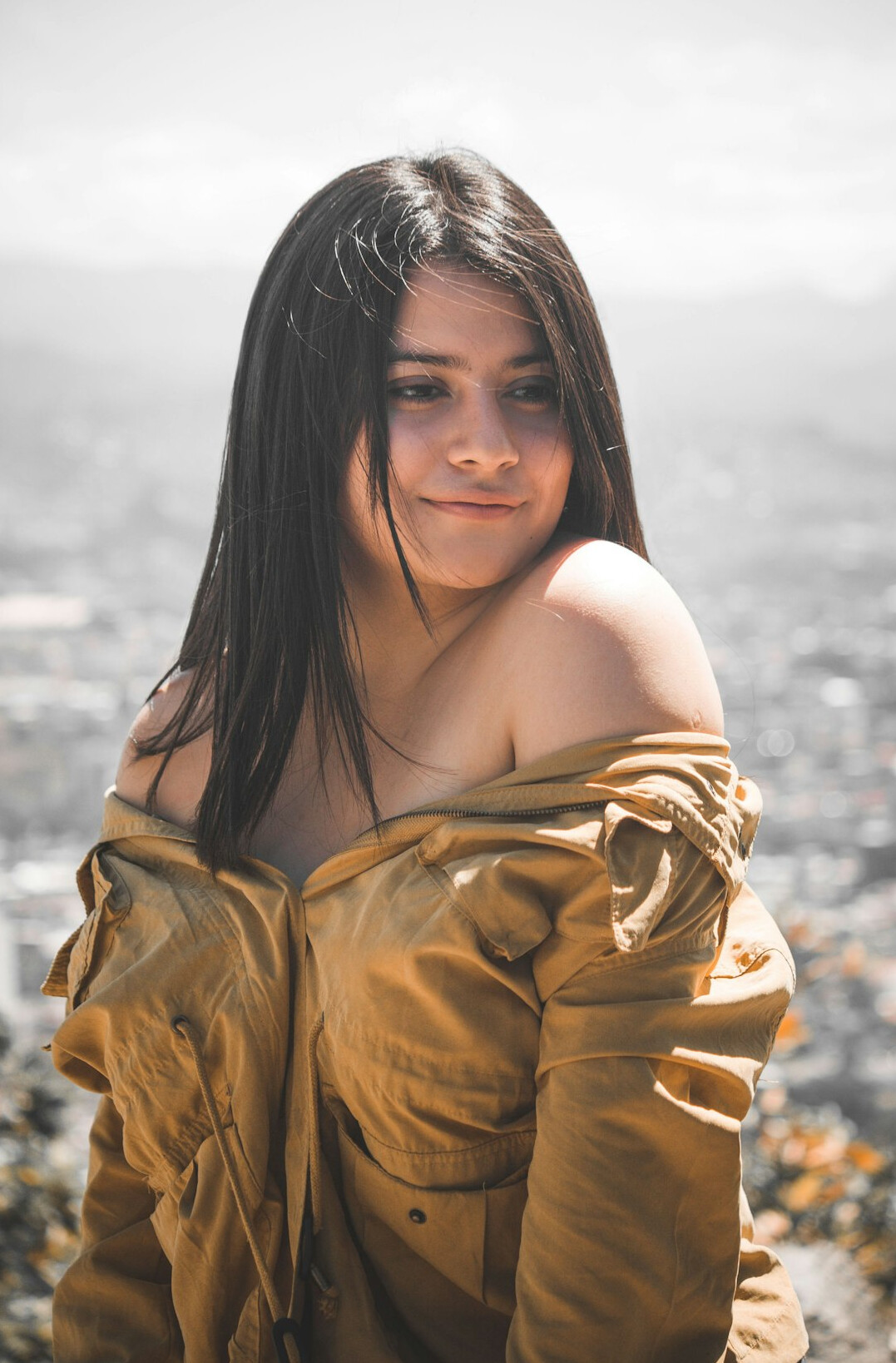 Portrait of a young woman with dark hair smiling